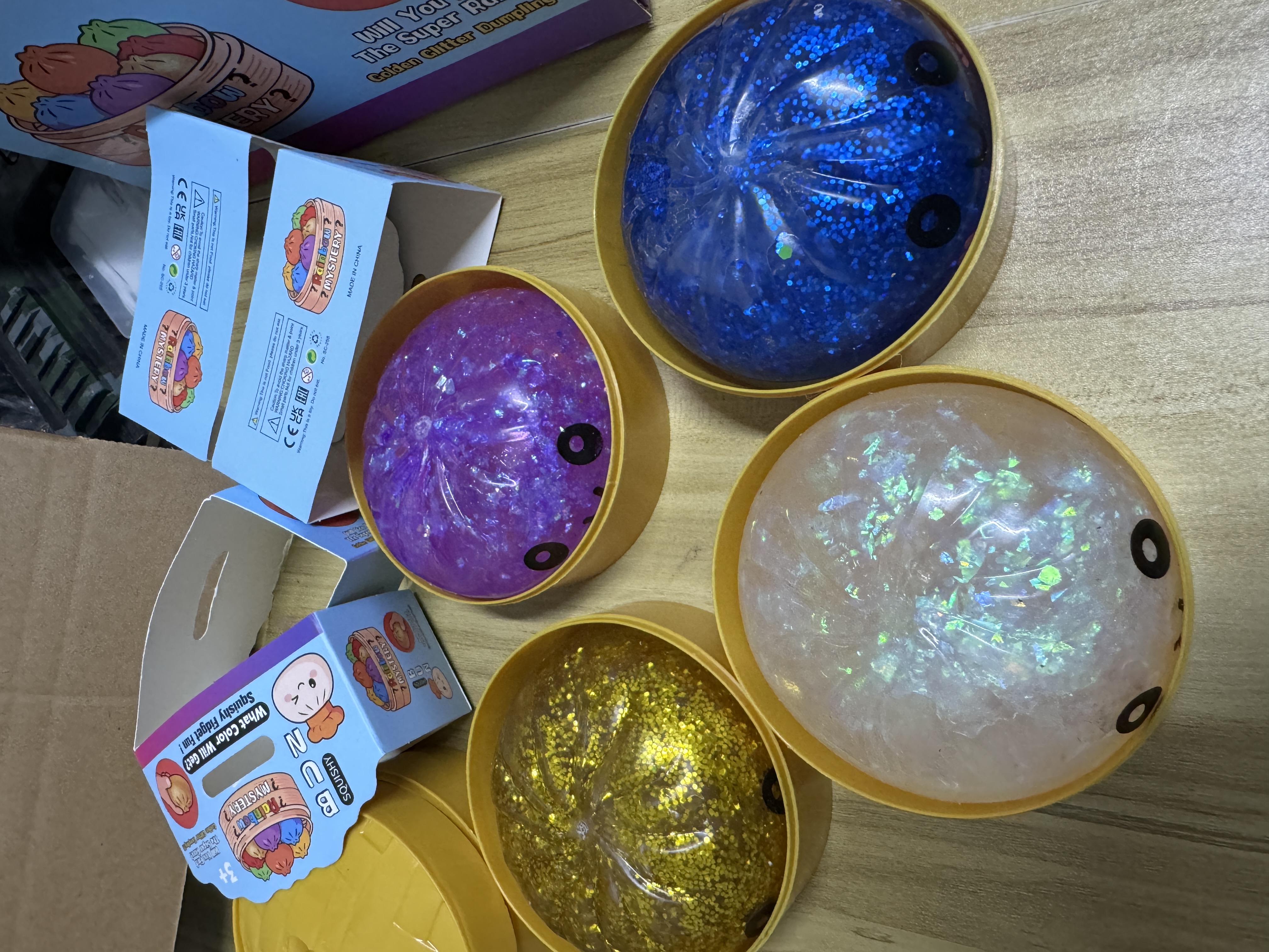 Retail-ready display box for the Maltose Syrup Smiling Bun, featuring a clear window and 'What Color Will You Get?' messaging.